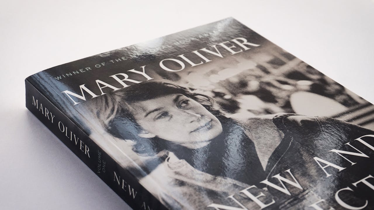 services-01 Close-up of a Mary Oliver poetry book with a vintage black and white cover.